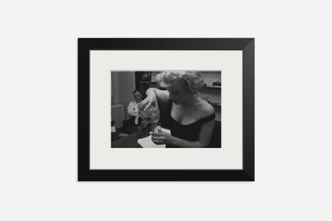 Marilyn Monroe Pouring A Drink Framed Print